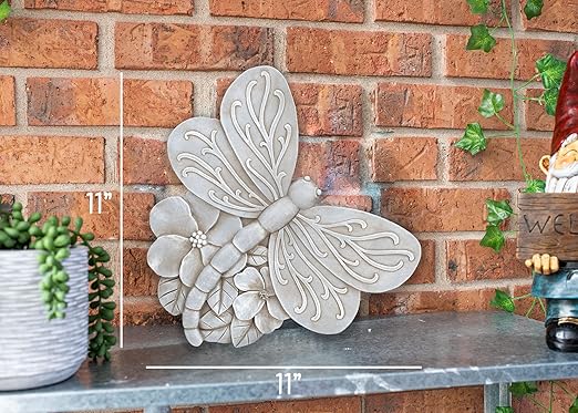 Grey dragonfly cast resin stepping stone sculpture with raised wing engravings and petals