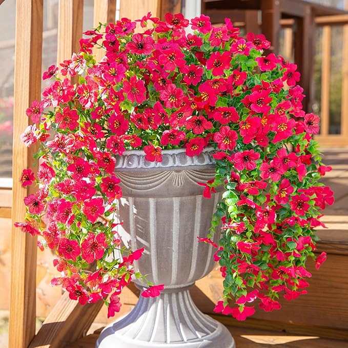 Hot pink faux daisy hanging flower bundles with trailing green leaves