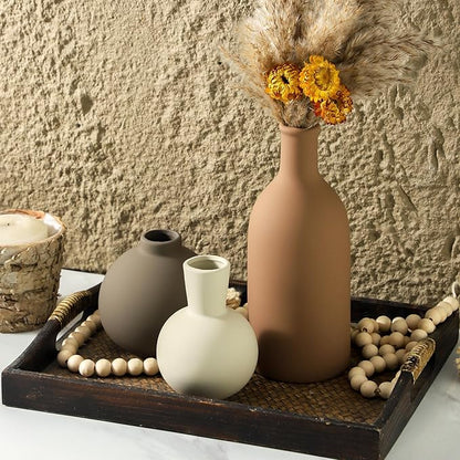 Ceramic vase set: tall terracotta-brown vase, white bulb vase, and taupe round vase