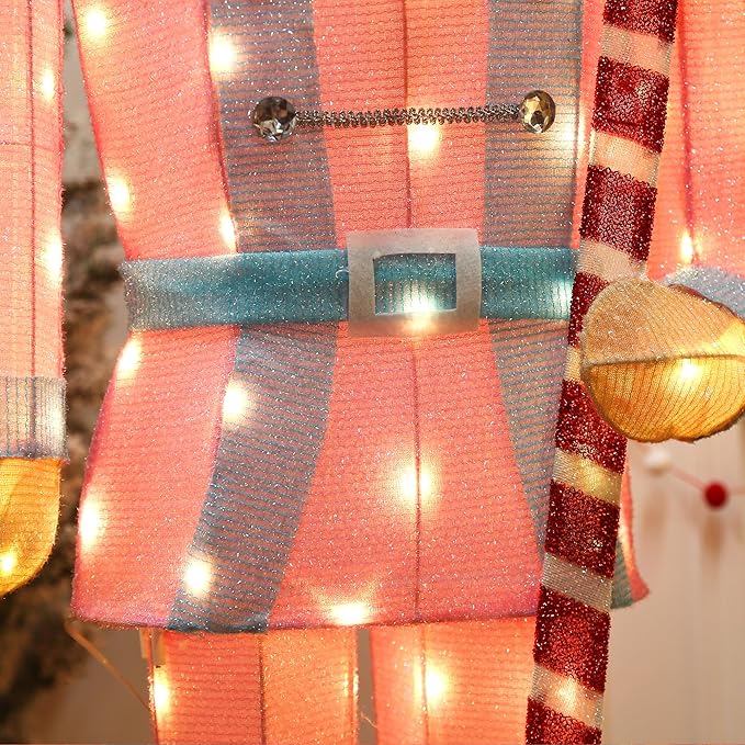 Close-up of LED-lit nutcracker torso in red, orange, and turquoise with warm glowing bulbs