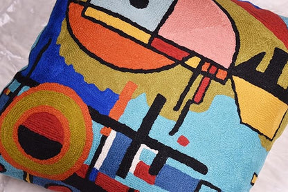 Blue abstract pillow cover detail with large face shape and orange outline