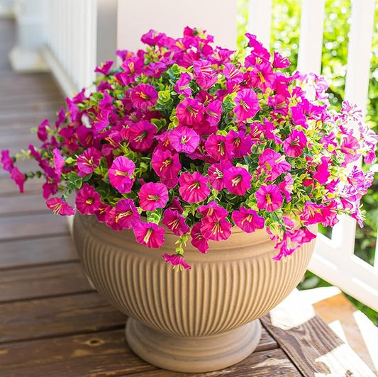 Fuchsia faux morning glory flower mix with green leaves in a planter