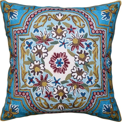 Turquoise floral embroidered pillow cover with central medallion and colorful Suzani motifs