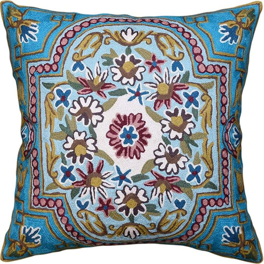 Turquoise floral embroidered pillow cover with central medallion and colorful Suzani motifs