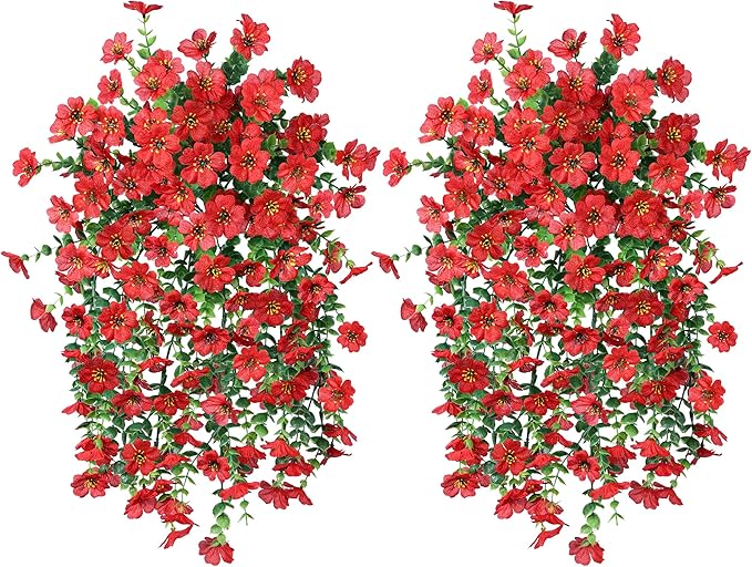 Two red faux hanging flower bundles with green leaves and trailing red blossoms