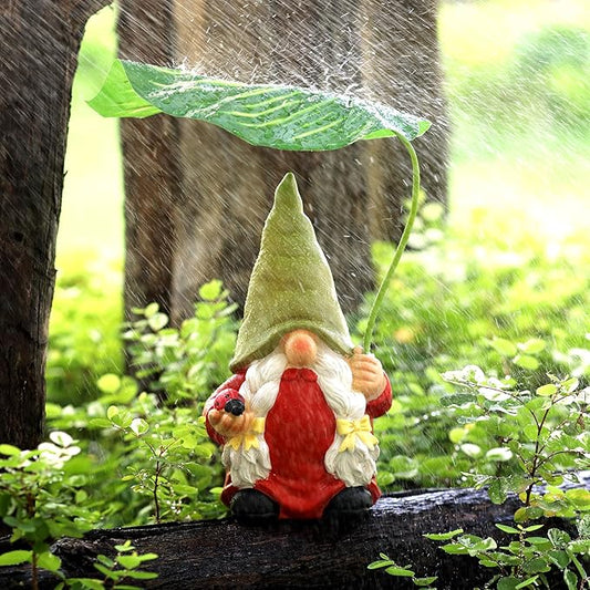 Garden gnome statue with red dress, white beard, and green leaf umbrella on ground