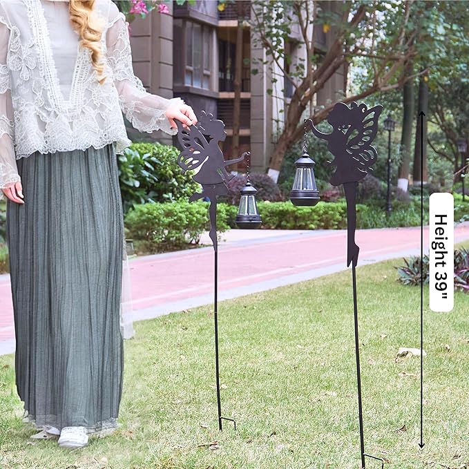 Two black metal fairy solar stake lights with lantern tops and butterfly-wing silhouettes