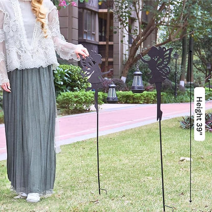 Two black metal fairy solar stake lights with lantern tops and butterfly-wing silhouettes