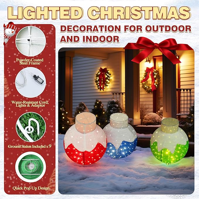 Three lit pop-up Christmas ball ornaments, red, blue and green, standing on bases