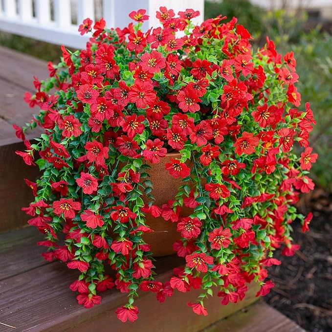 Red faux hanging flower bundle with green trailing vines, cascading red blooms