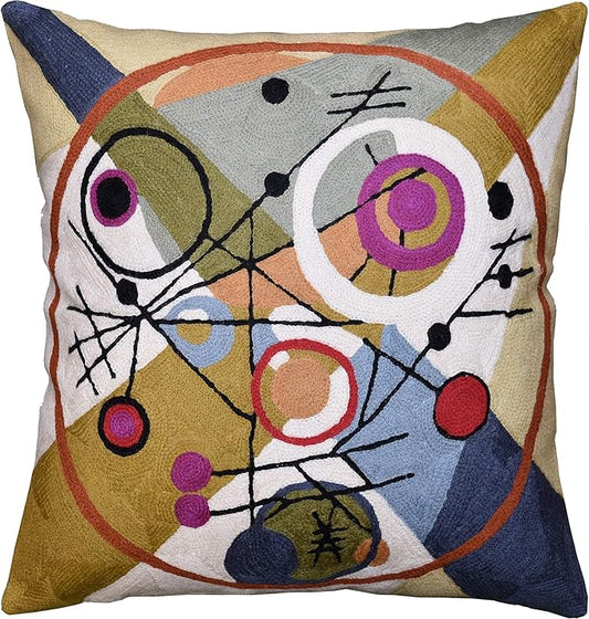 Abstract wool throw pillow cover with multicolor circle motif on cream background.