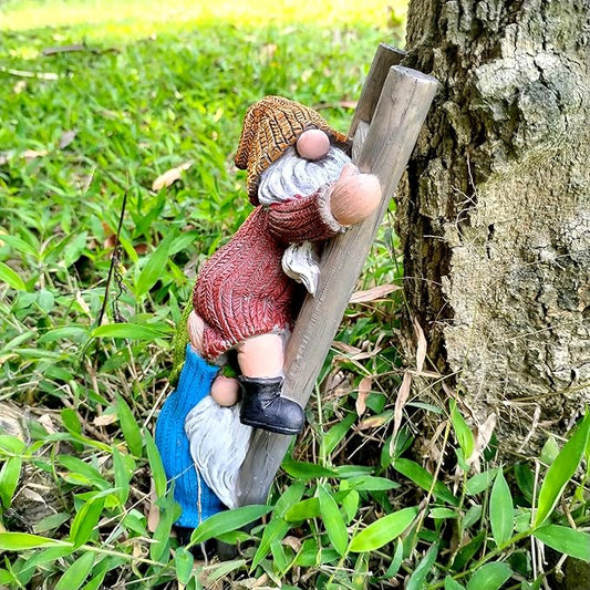 Side view of climbing ladder garden gnome statue with red sweater, blue pants, white beard