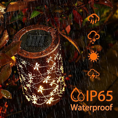 Brown waterproof solar lantern with white dragonfly and floral light pattern, glowing