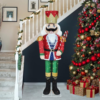 Standing lit nutcracker soldier in red coat and green pants with warm white lights