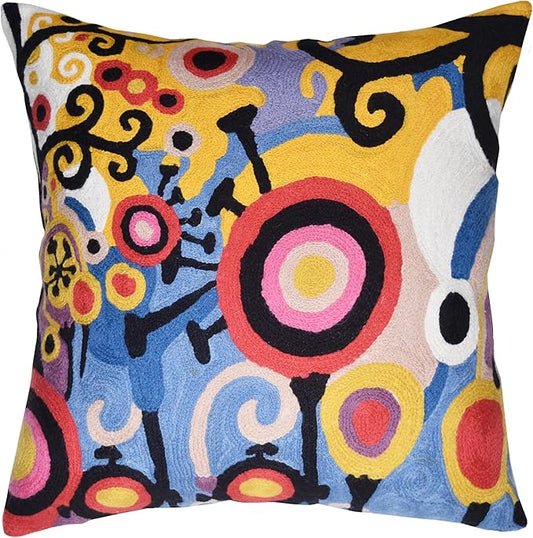 Colorful embroidered decorative pillow cover with abstract tree-and-life motifs in yellow, blue, and red.