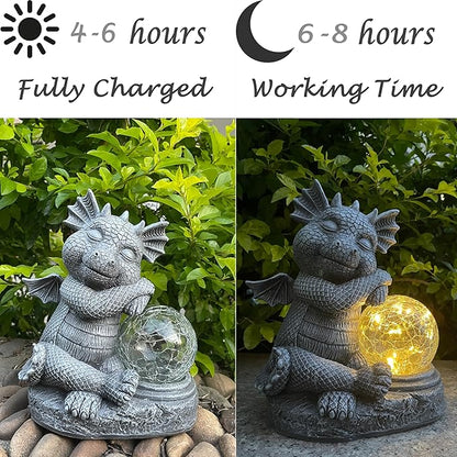 Gray dragon resin figurine holding glowing orb near leaves, outdoor solar decor