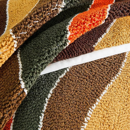 Tufted stripe pillow cover fabric close-up with looped yarn in green, brown, orange, tan