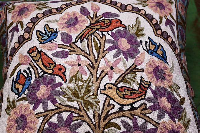 Front close-up of tree-and-birds needlepoint pillow cover with purple flower blooms