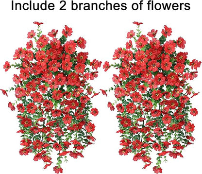 Two red faux hanging flower bundles with dense green vines and small red blossoms