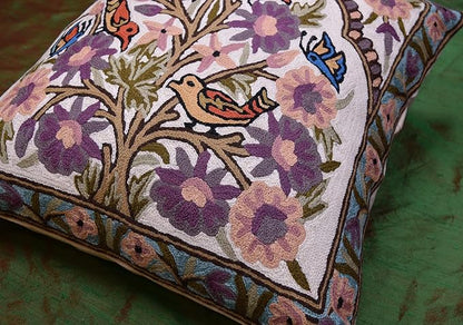 Floral bird pillow cover close-up on tree branches with purple and blue birds