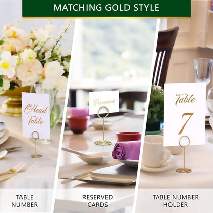 Gold table number holder and other place card displays arranged at a wedding setting