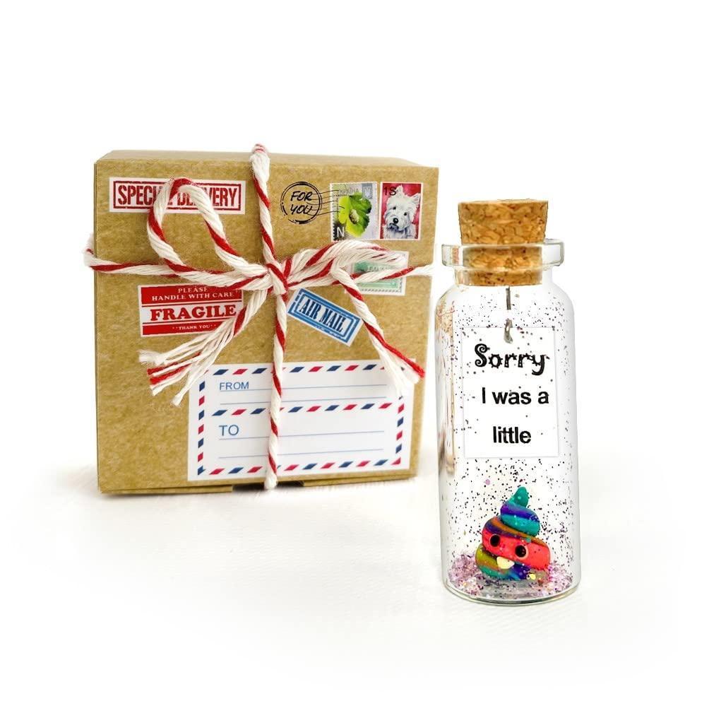 Apology message bottle in cork jar with label, beside ribbon-tied kraft craft gift box