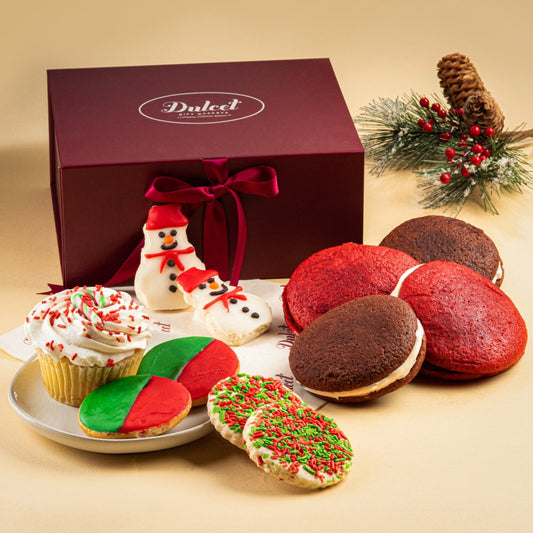 Holiday gift basket with burgundy box, ribbon, and assorted cookies and treats