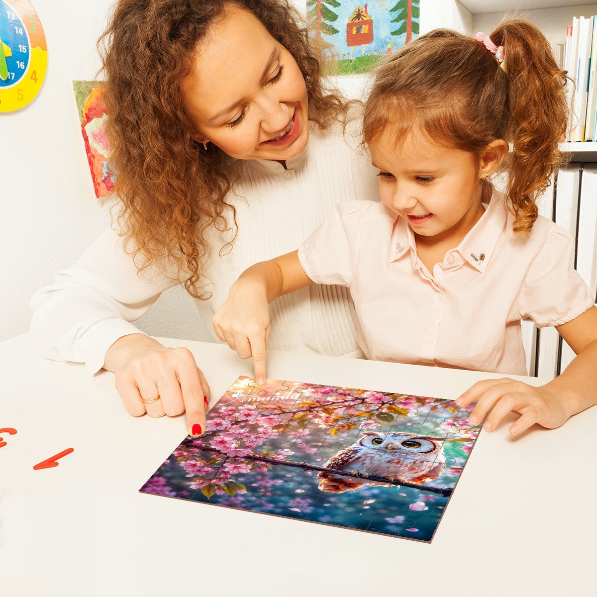 Jigsaw puzzle being assembled by two children, owl and blossoms artwork visible