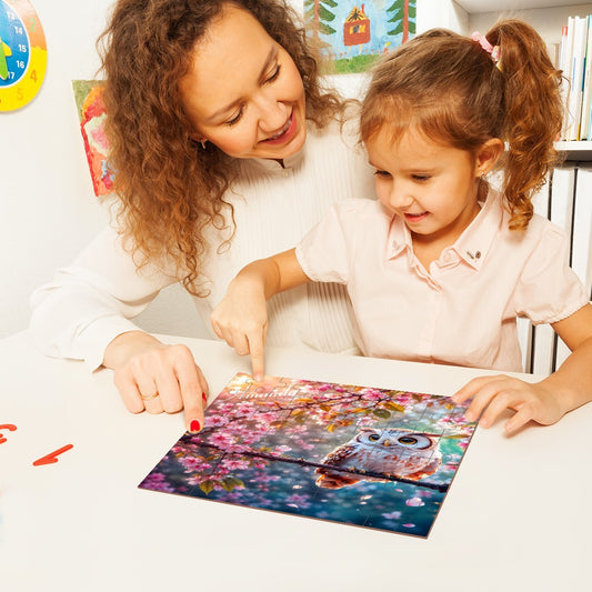 Kids assembling a wooden jigsaw puzzle with owl and cherry blossom artwork