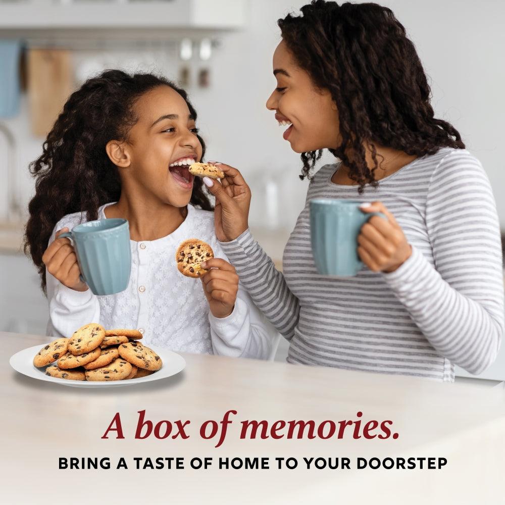 Two people smiling while eating chocolate chip and crinkle cookies