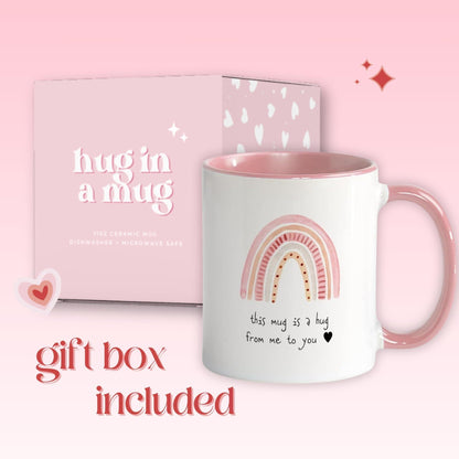 Pink-handled ceramic mug with rainbow hug design, shown with gift box packaging