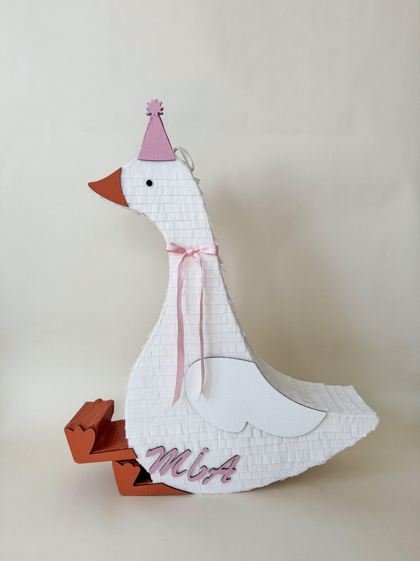 32” sitting goose piñata with white tissue body, pink hat and ribbon