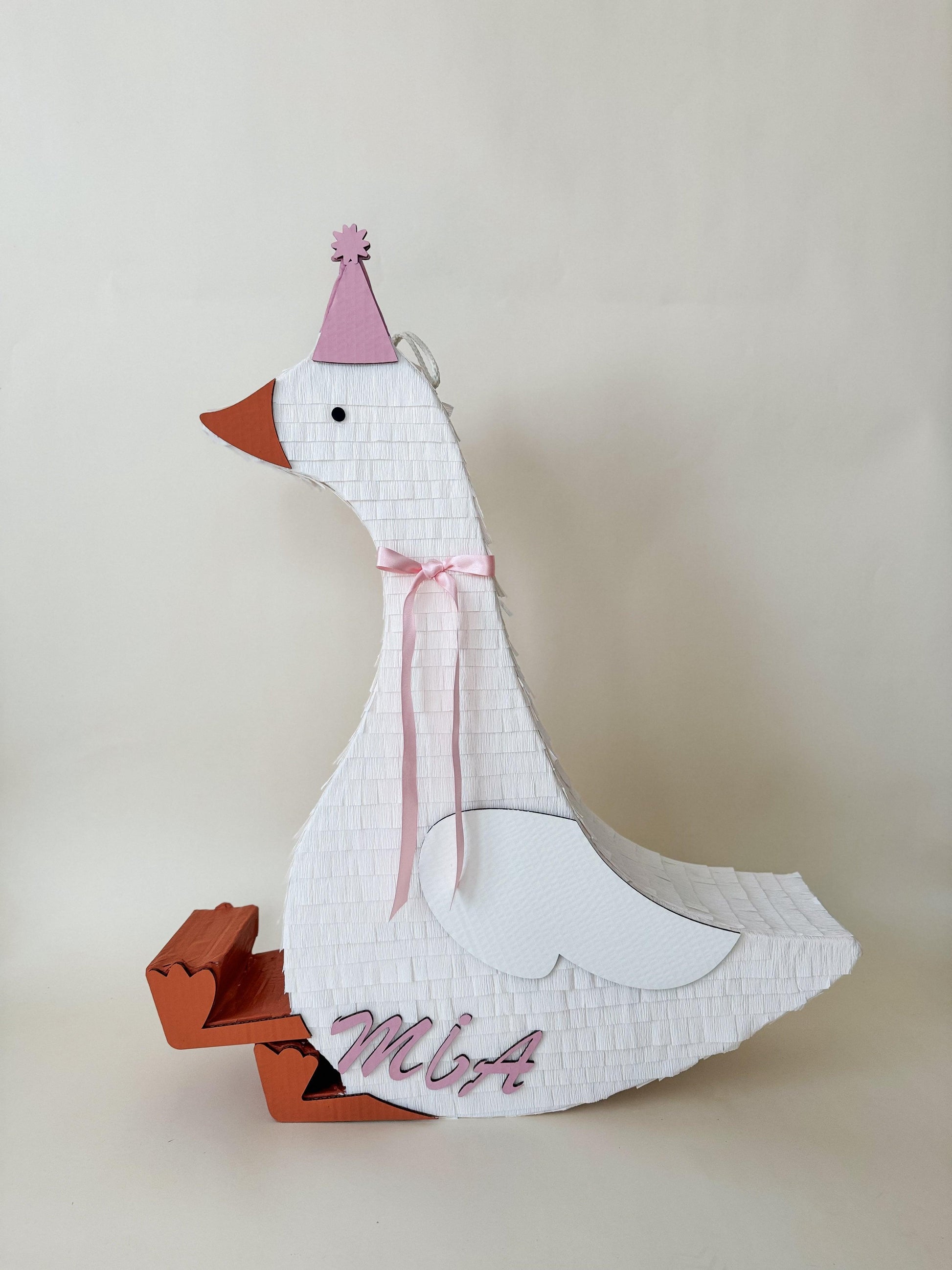 32” sitting goose piñata with white tissue body, pink hat and ribbon