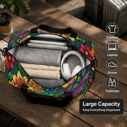 Floral duffel bag opened with folded clothes and headphones inside, black straps