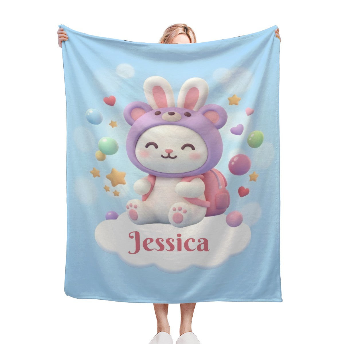 Light blue bunny character blanket with purple ears and “Jessica” on the center