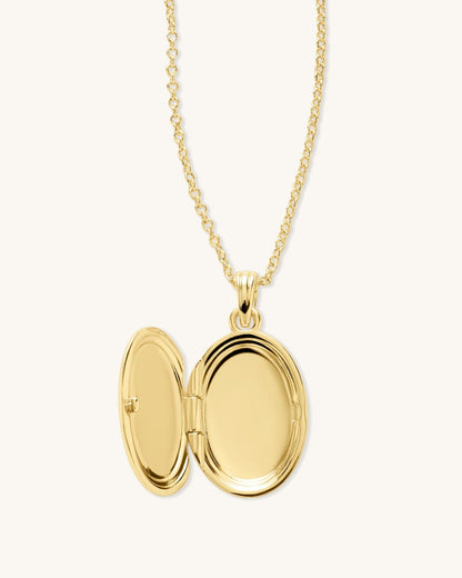 Gold oval locket necklace with hinged open oval pendant and chain