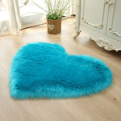 Heart-shaped faux fur rug with long shag pile, bright blue plush carpet mat.