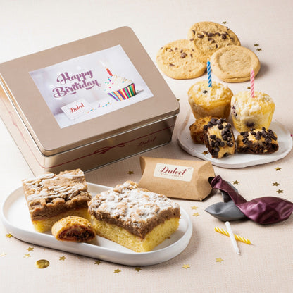 Deluxe birthday gift tin with assorted cookies and cake on plates
