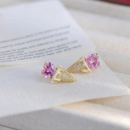Pink heart and gold-tone triangular glitter earrings, side view on display