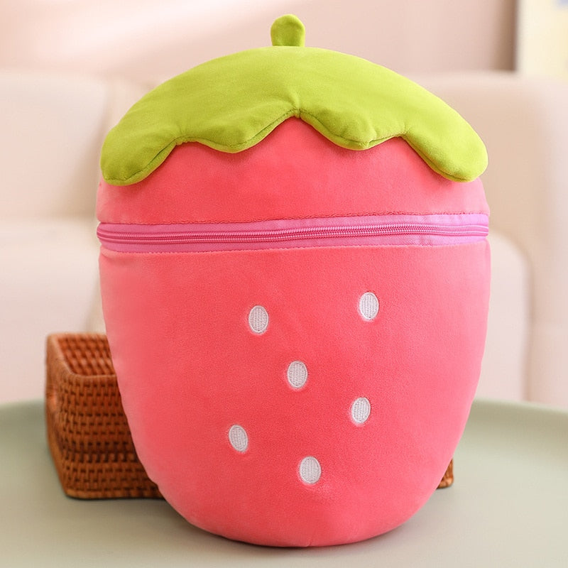 Strawberry-shaped plush animal, pink body with green leafy top and white dot accents