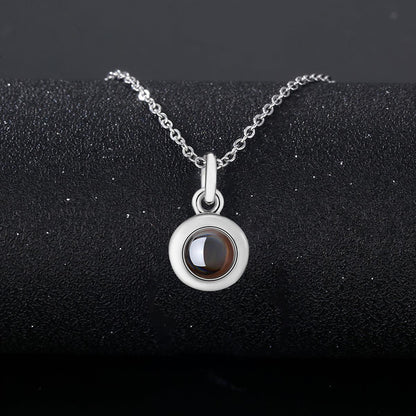 Silver photo projection necklace with round locket pendant and link chain