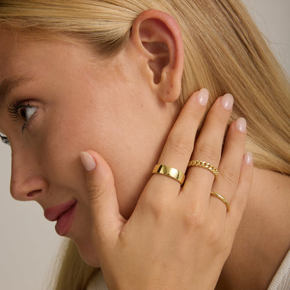 Gold curb chain ring with wide open-link band, worn on finger