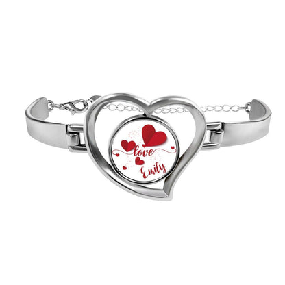 Heart charm bracelet with silver clasp and red heart locket reading "Love Emily"