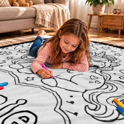 Black-and-white doodle coloring blanket with unicorn outline and stars on a couch