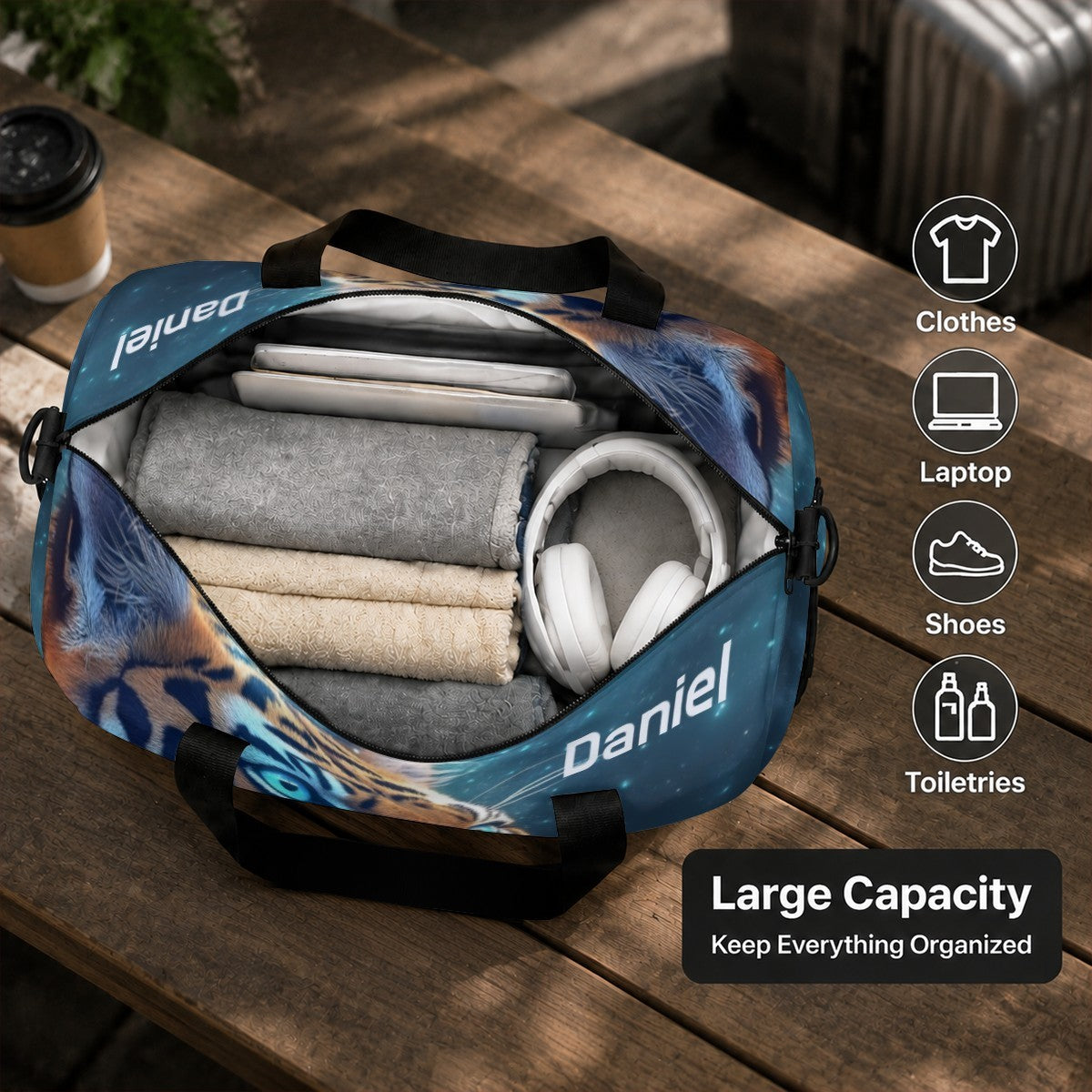 Opened tiger-print duffel bag showing organized clothes, and headphones inside.