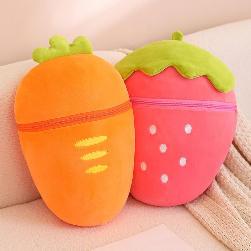 Pair of fruit animal plushies: orange carrot pod and pink strawberry pod with green leafy tops