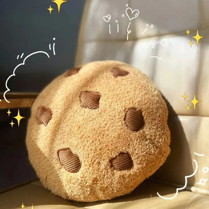 Round cookie plush pillow in tan with brown stitched chocolate-chip shapes