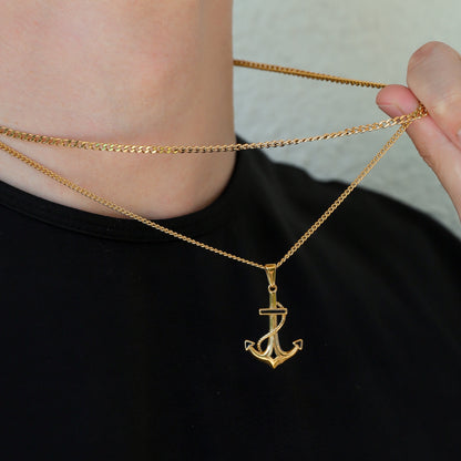 Gold anchor pendant Cuban link necklace set, chain held near pendant detail