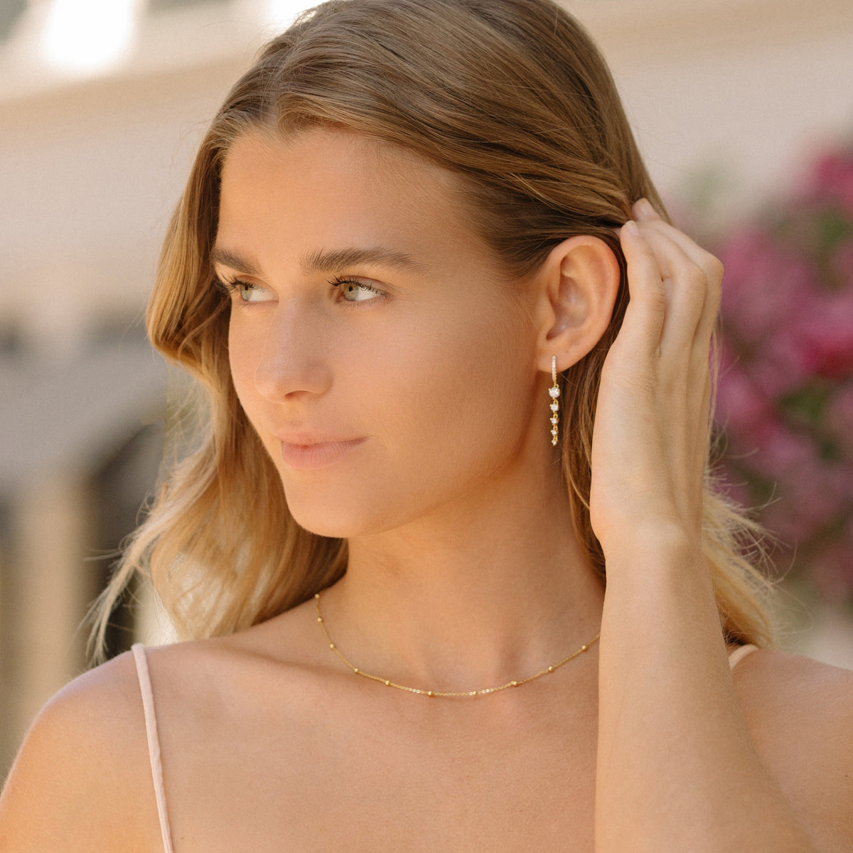 Gold satellite chain necklace with small bead stations, worn close to the neck