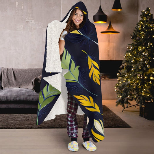 Botanical leaf hooded blanket in navy with green and yellow leaves; wearable hood and cape.
